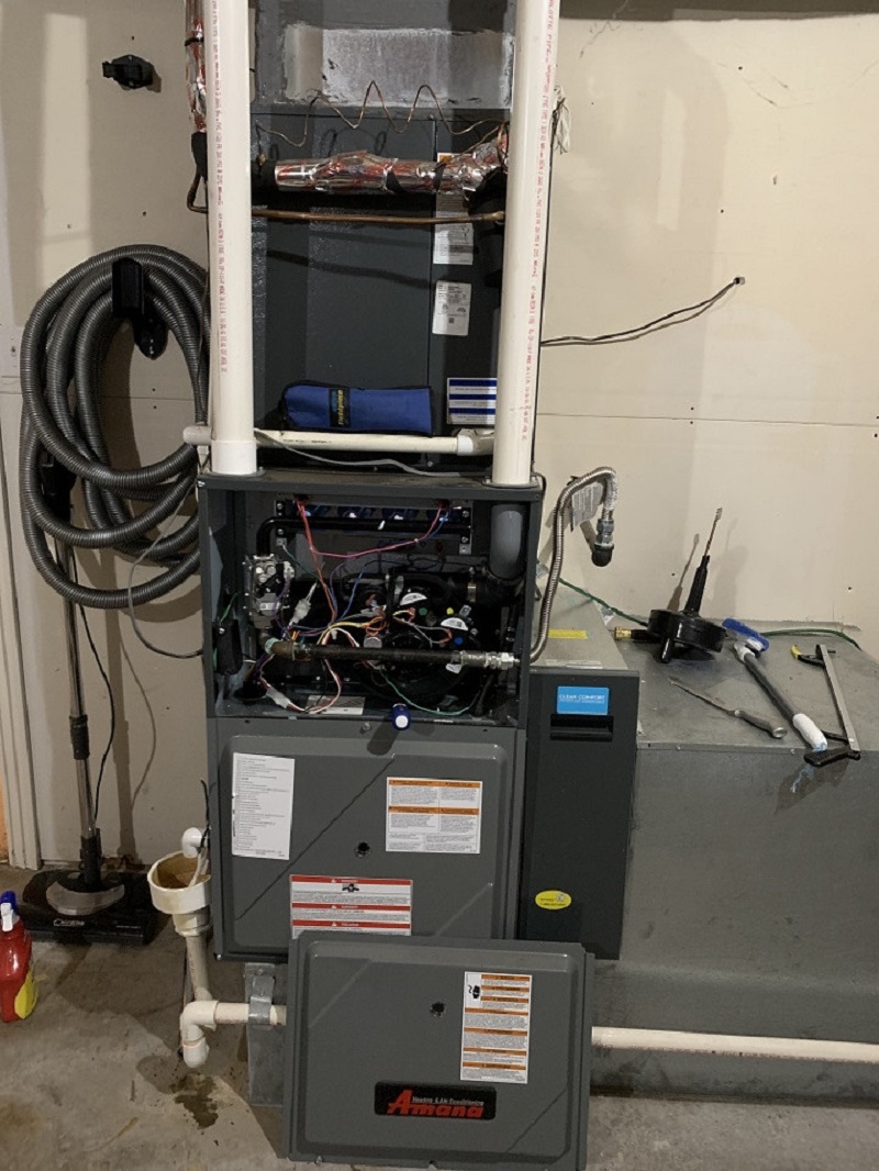 Tom's Heating & Air technician work — Amana furnace service in a River Valley home