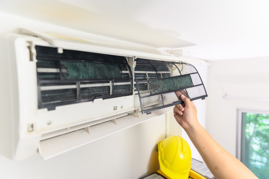 HVAC technician working on the air conditioning unit